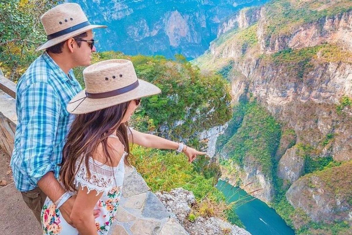 a man and a woman looking at the view of the grand canyon