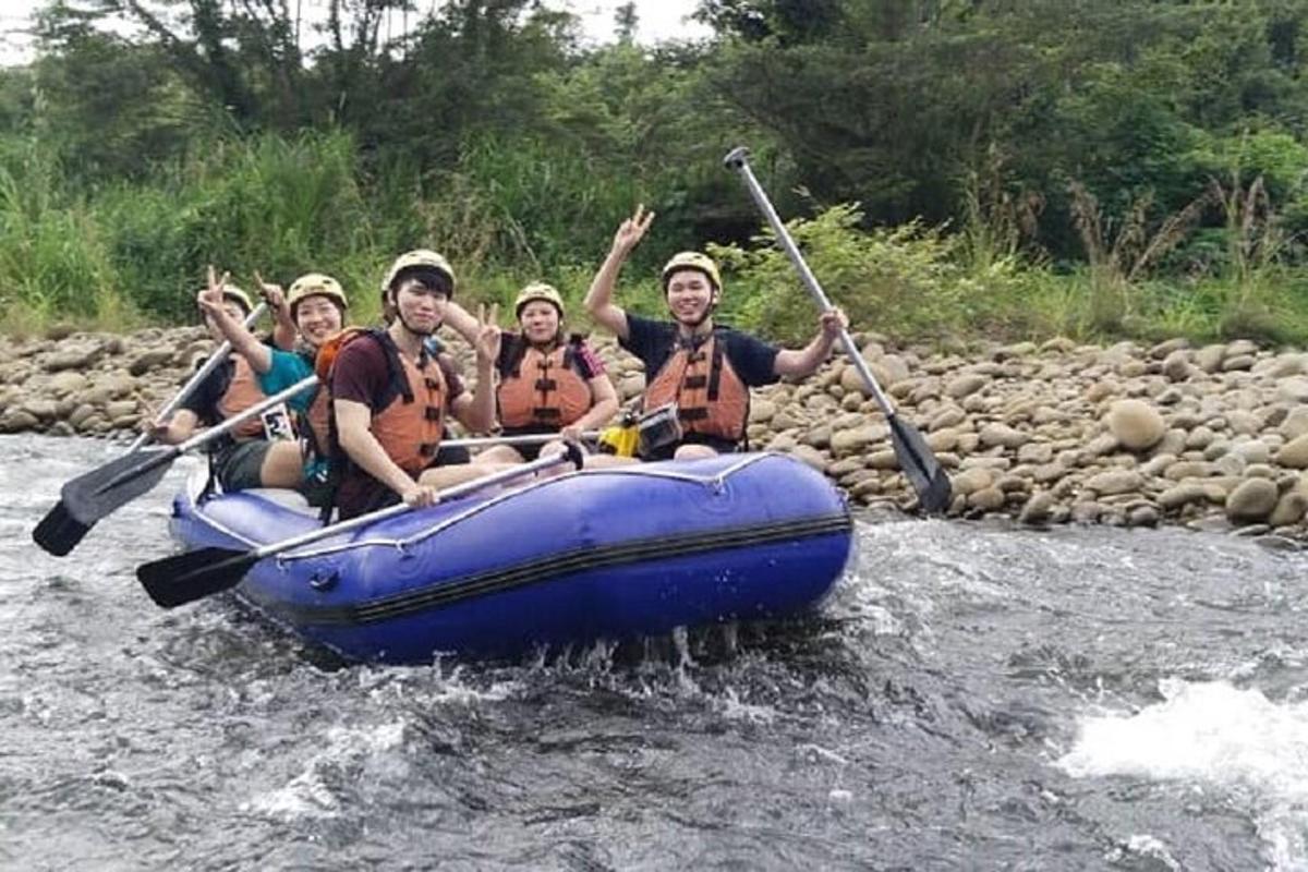 a group of people in a raft in a river