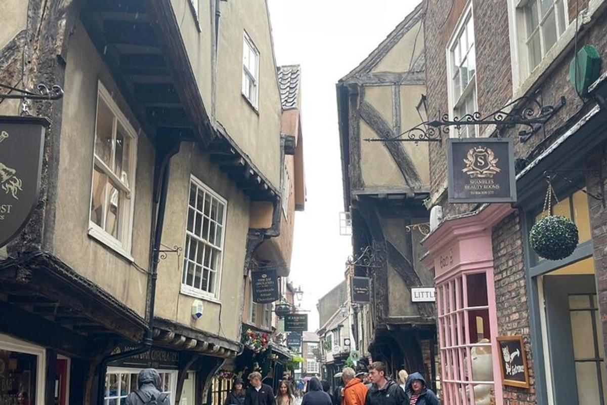 a group of people walking down a street with buildings
