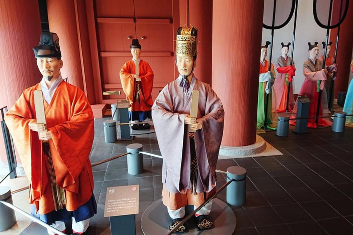 two statues of men in uniform on display in a museum