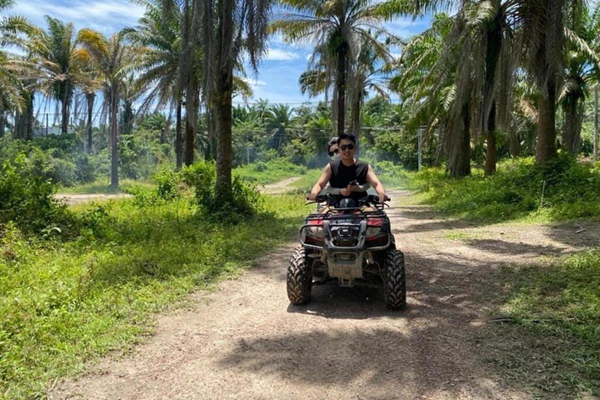 a man riding a quad bike on a dirt road