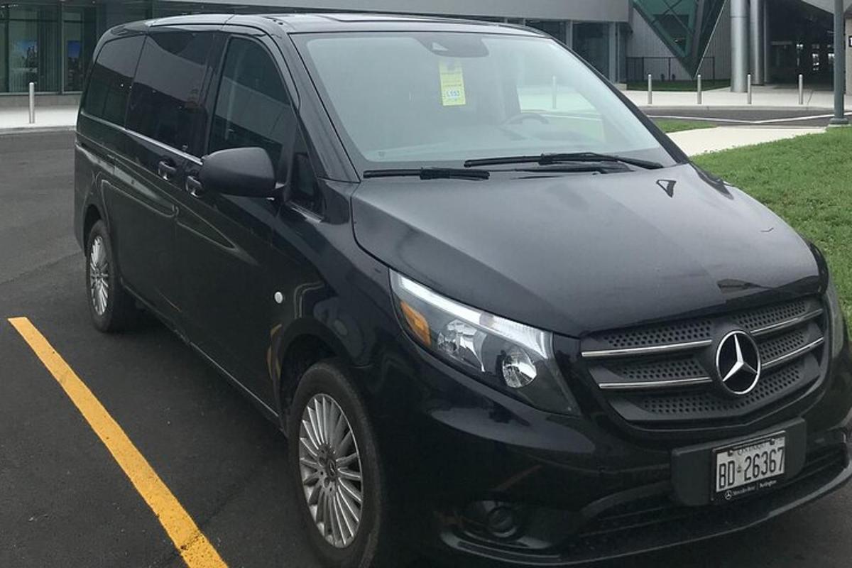 a black mercedes benz van parked in a parking lot
