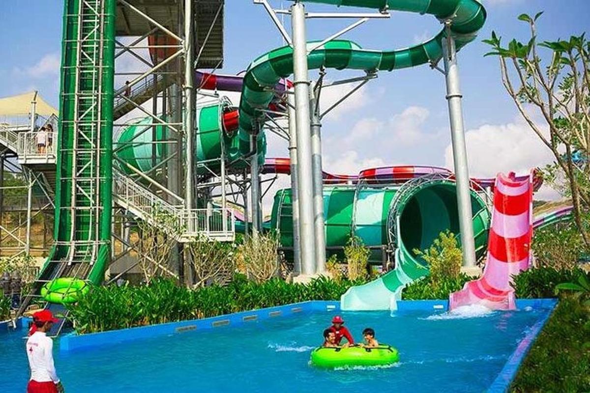 a water park with a water slide and people in a raft