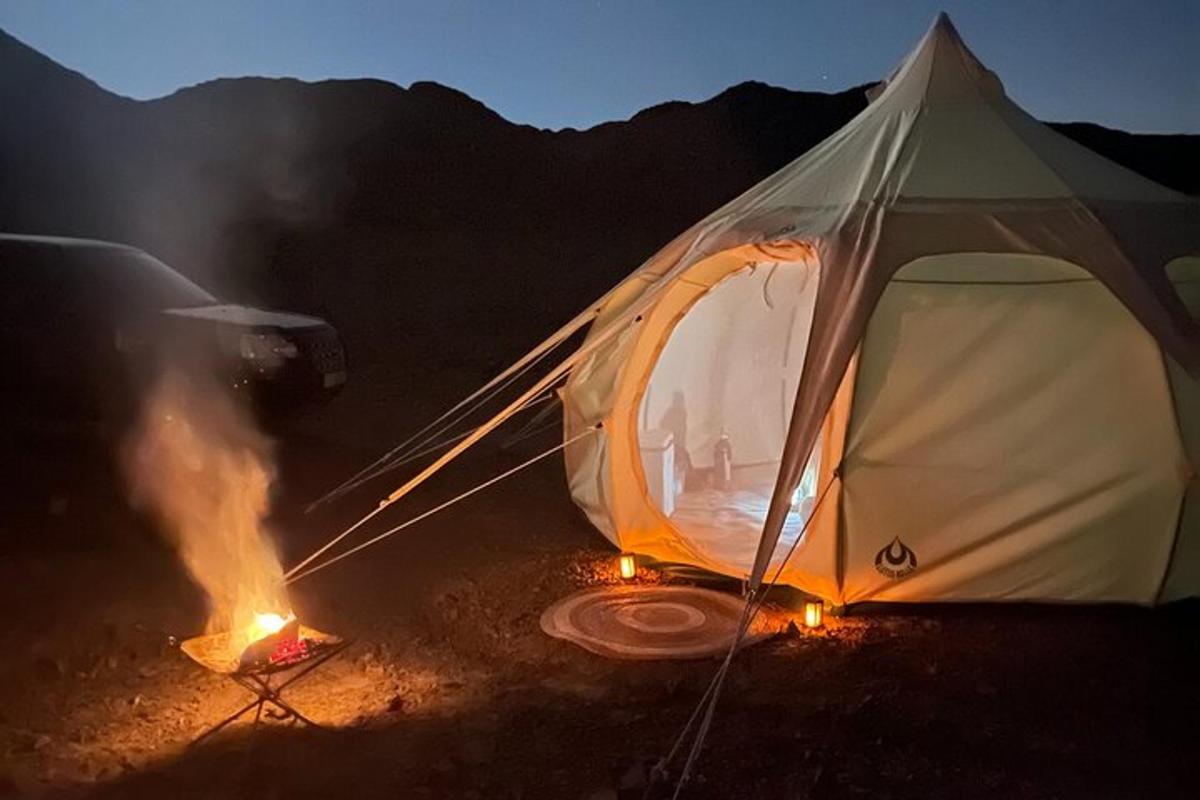 a tent with a fire in front of it