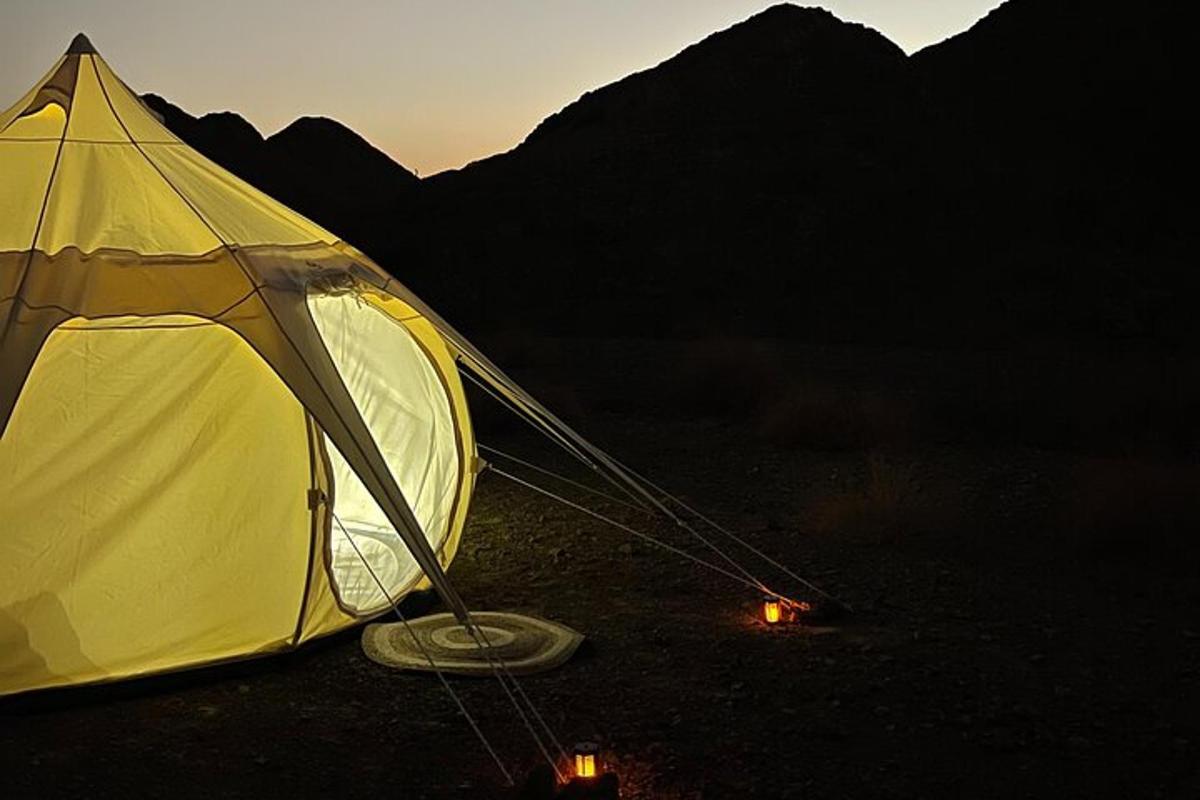 a yellow tent sitting in the middle of a field