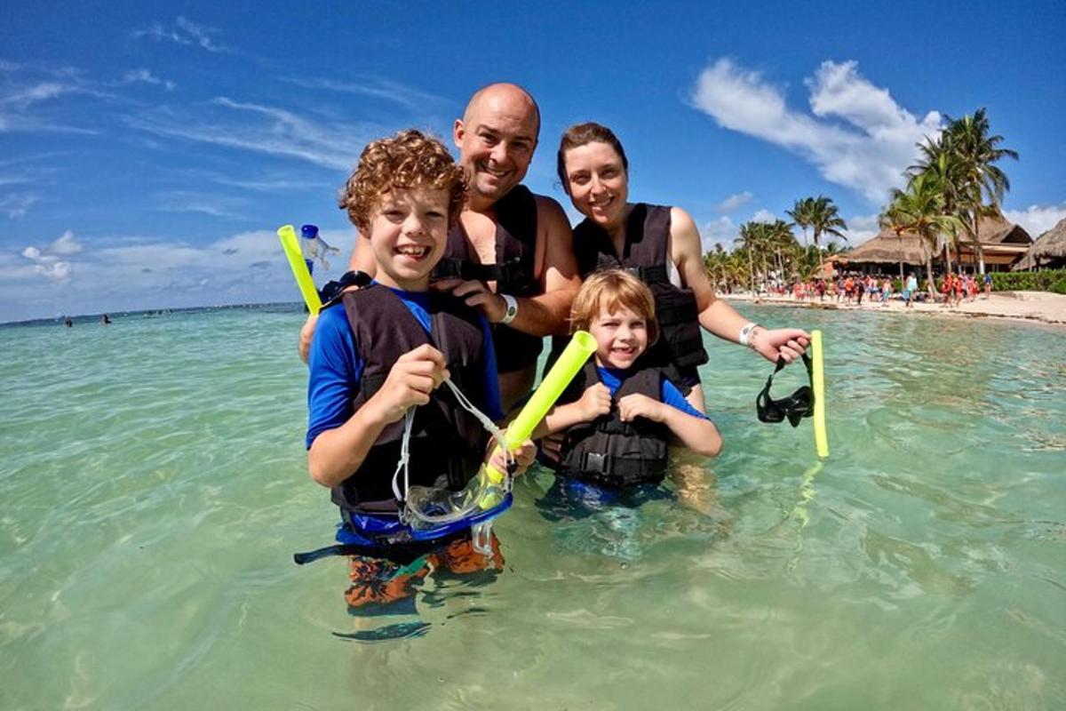a family standing in the water in the ocean