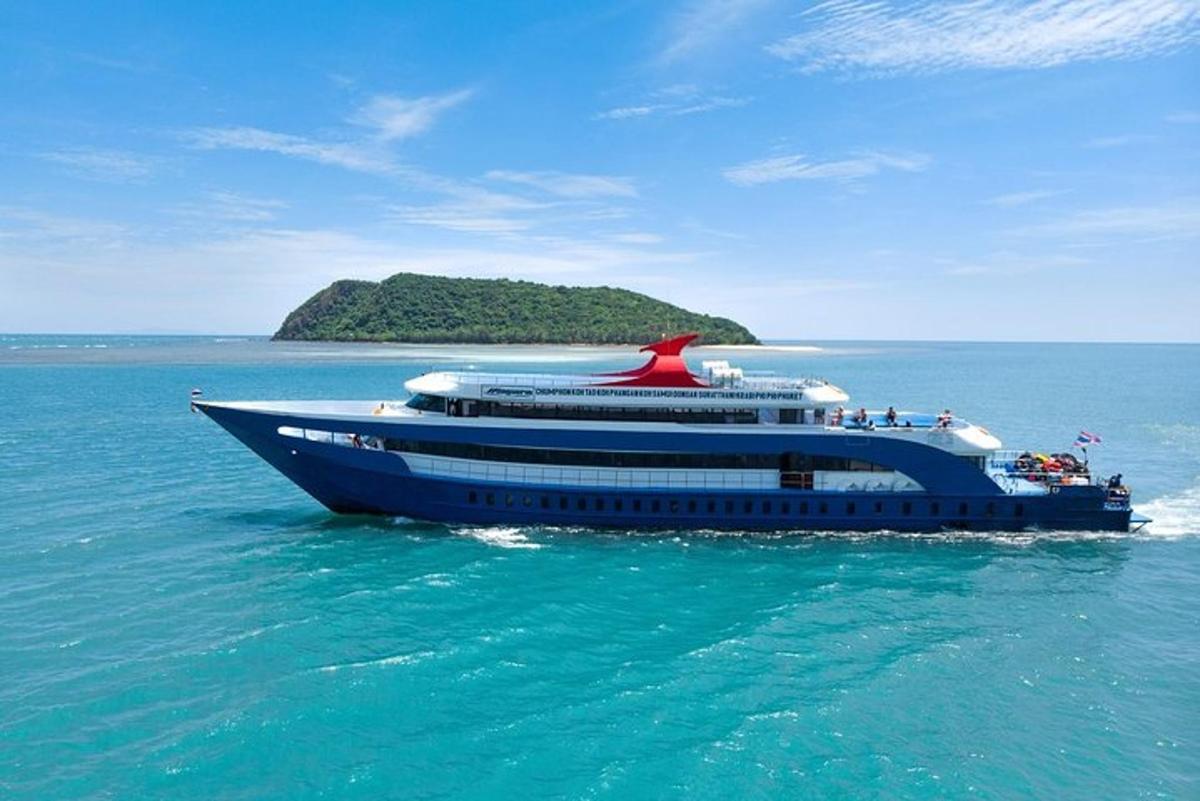 a cruise ship in the ocean with an island in the background