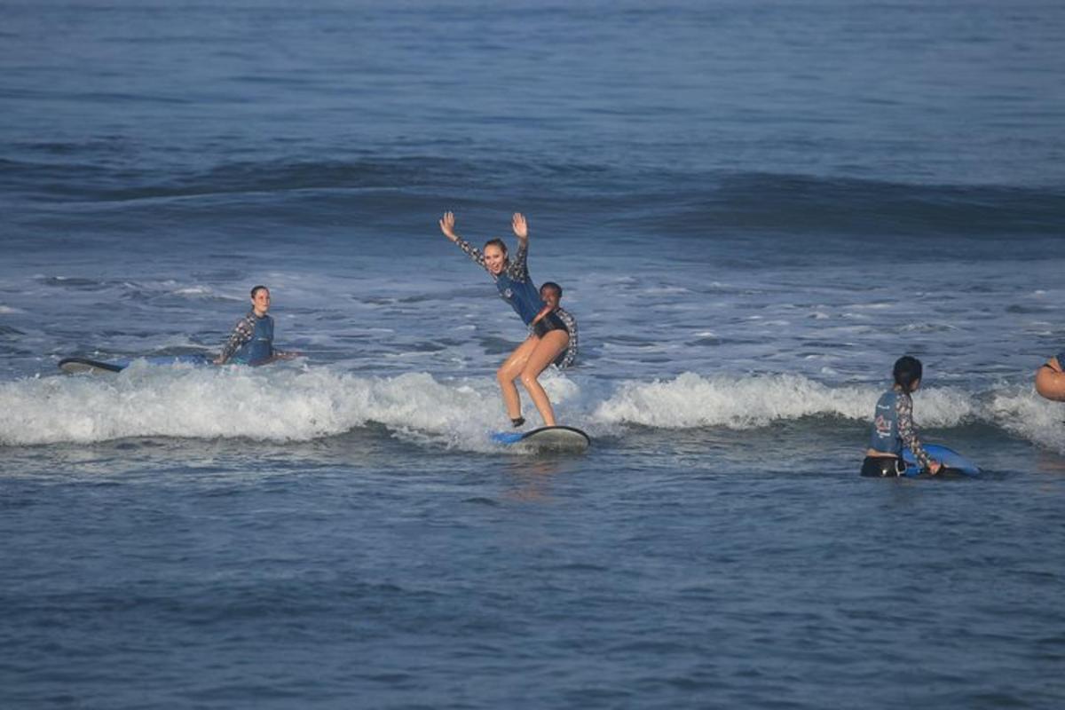 a woman riding a wave on a surfboard in the ocean