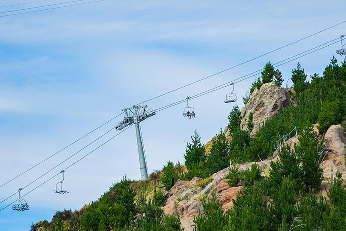 a ski lift going up a mountain with trees