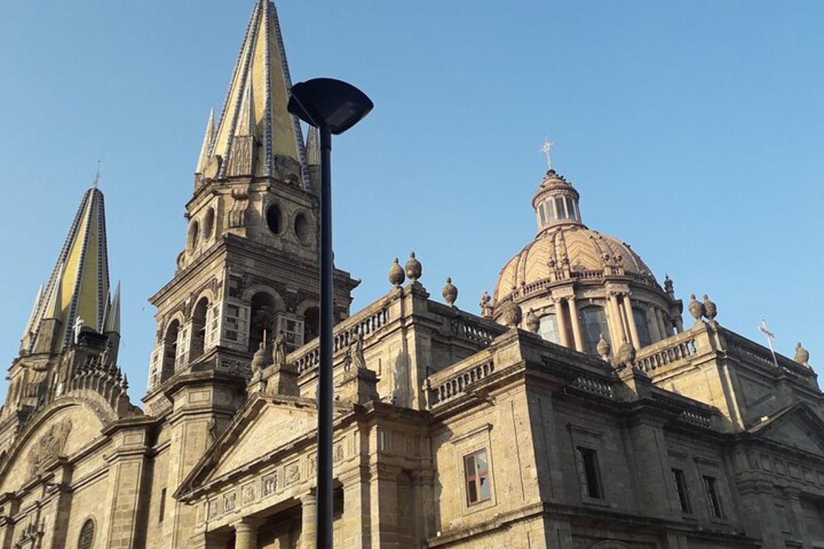 an old building with two towers and a street light