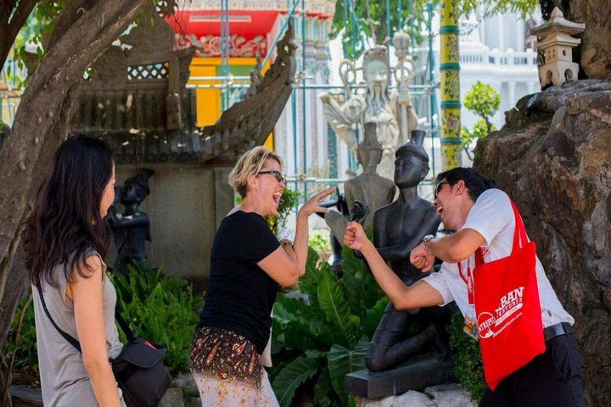 a man and woman taking a picture of a statue