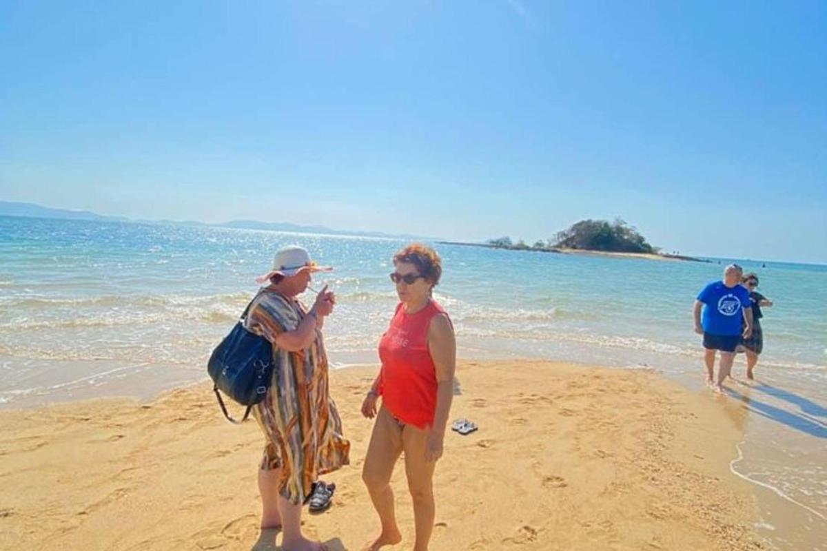 a man and a woman walking on the beach