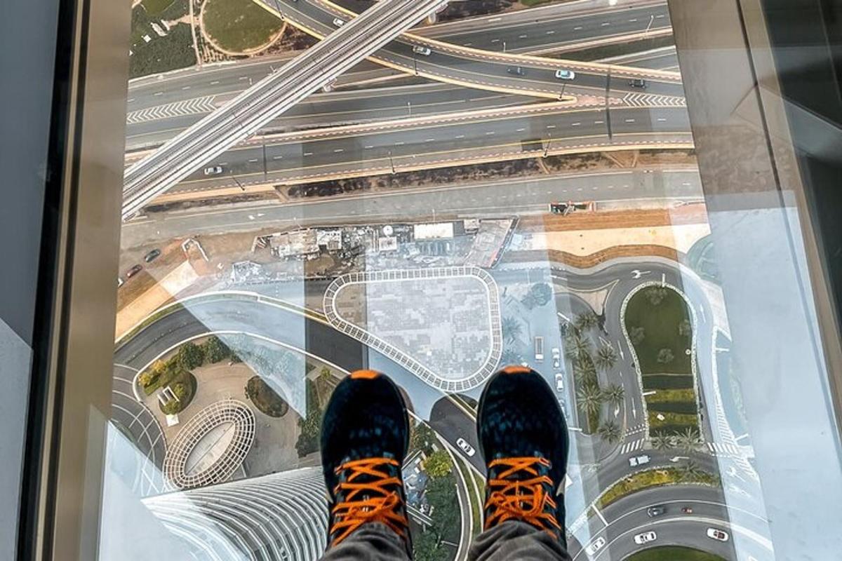 a person standing on the glass floor of a building