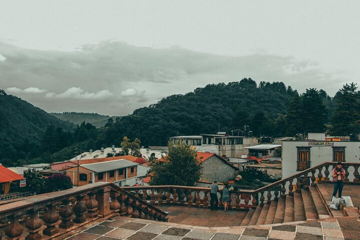a group of people standing on a bridge overlooking a town