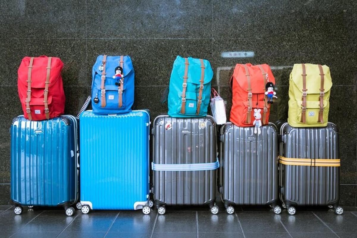 a group of suitcases lined up against a wall