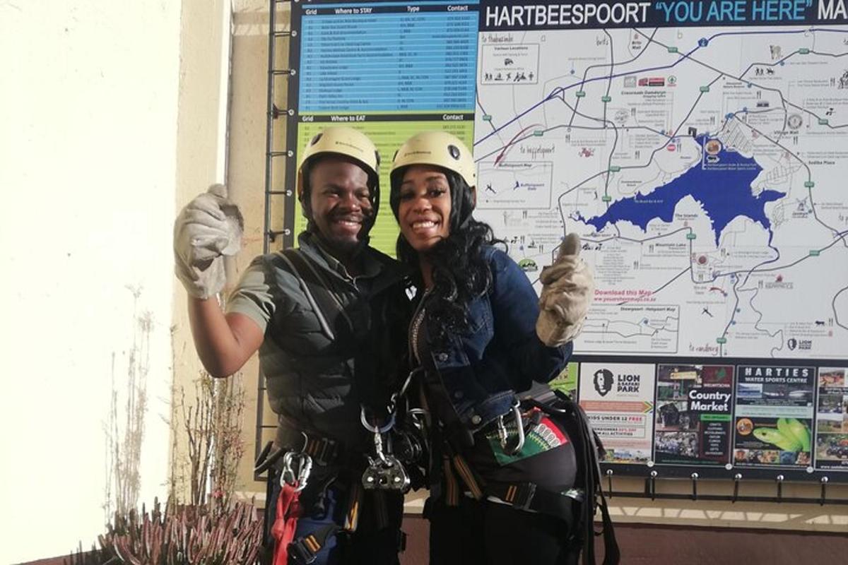 a man and woman giving thumbs up in front of a map