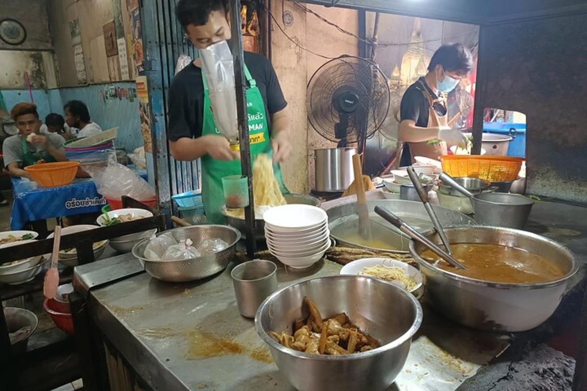 a group of people in a kitchen preparing food