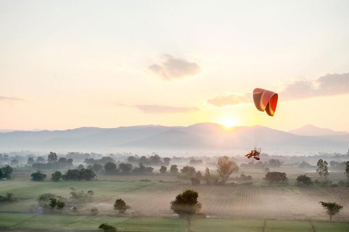 a kite flying in the sky over a field
