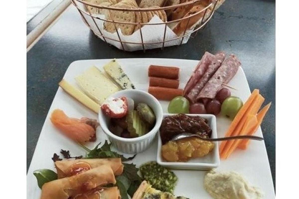a plate of cheese and vegetables on a table