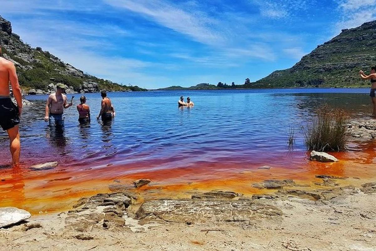 a group of people swimming in a lake with colored water