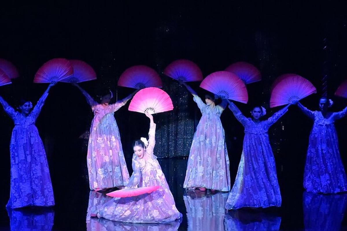 a group of women holding umbrellas on the stage