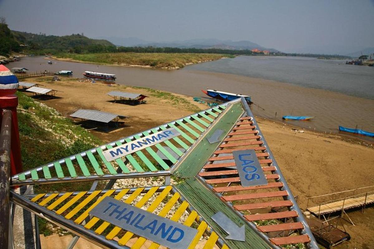 a hazard sign on a beach next to a river