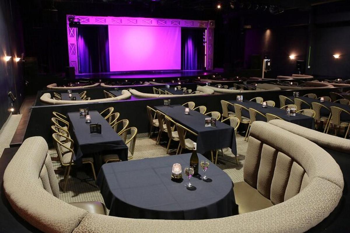 a room with tables and chairs and a purple screen