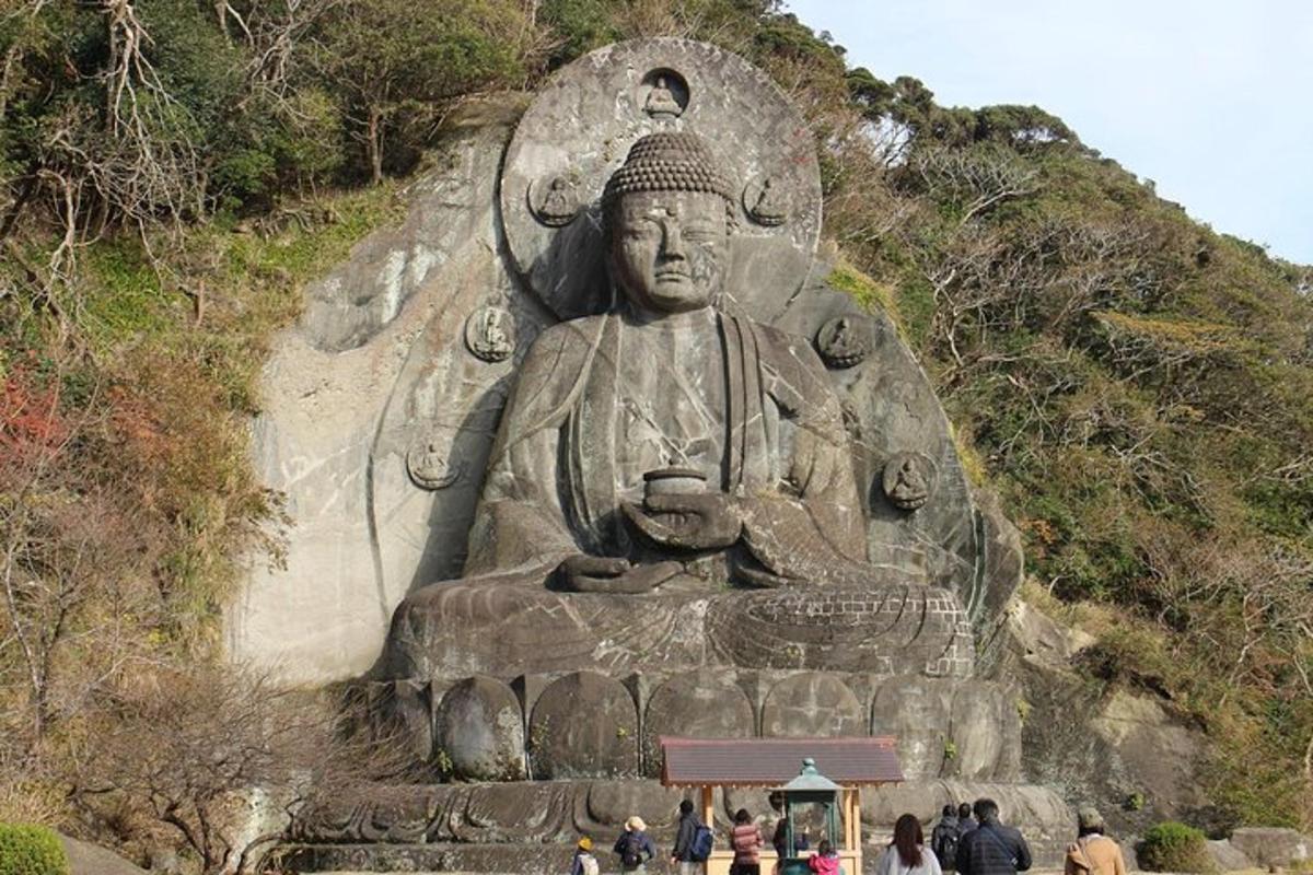 a large statue on the side of a hill