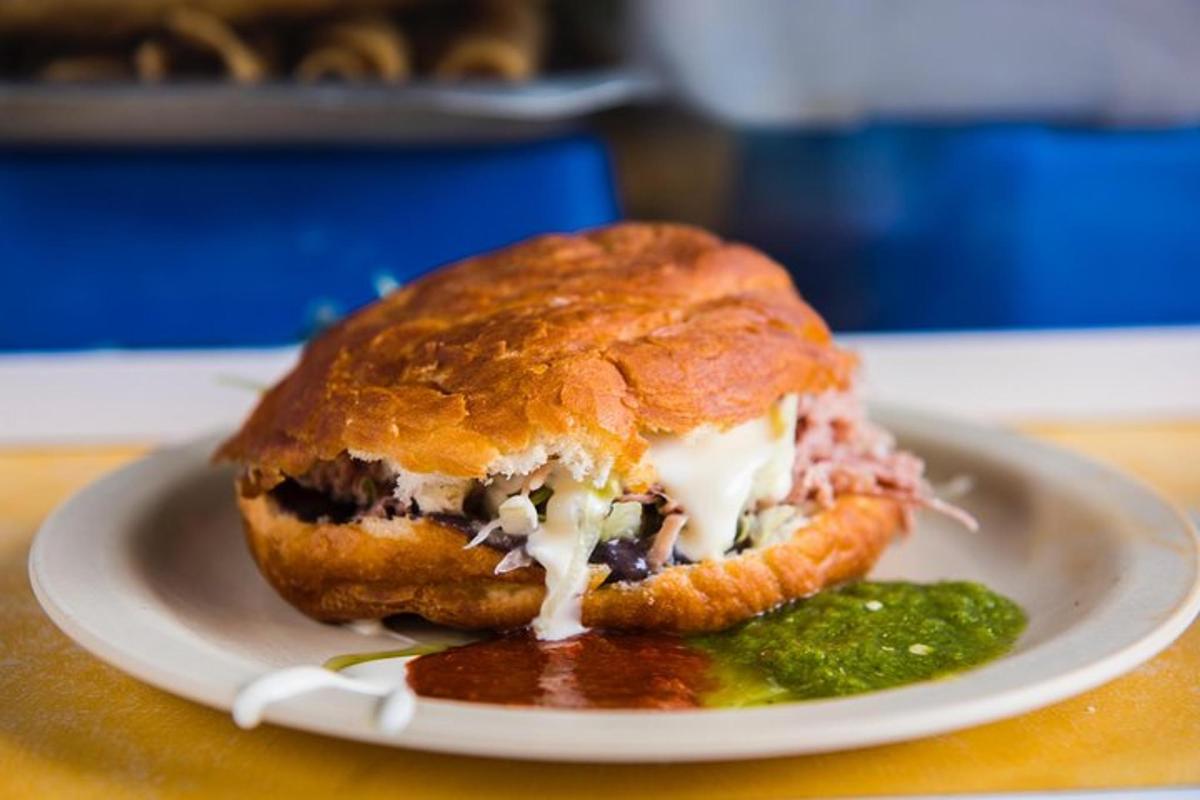 a sandwich on a plate with a pickle on a table