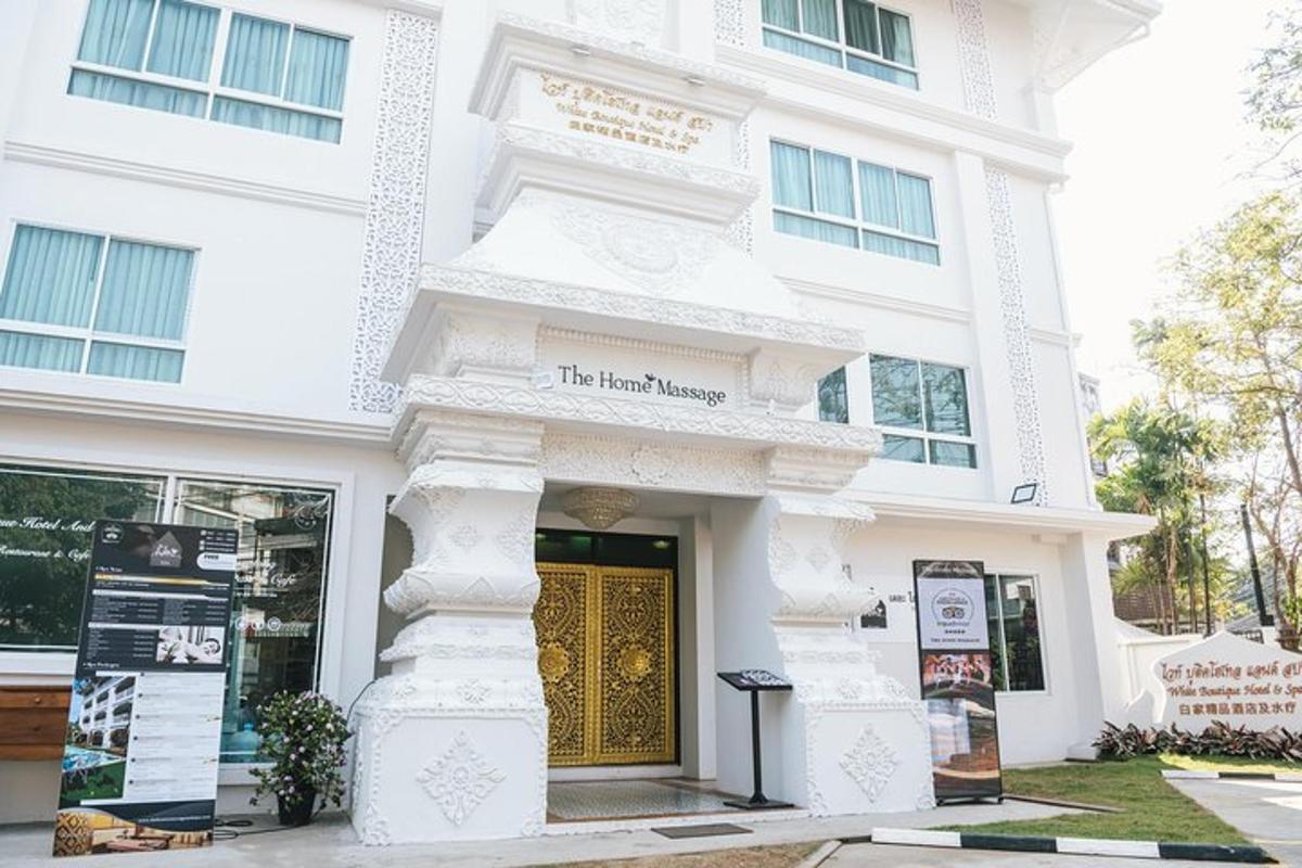 a white building with a gold door in front of it