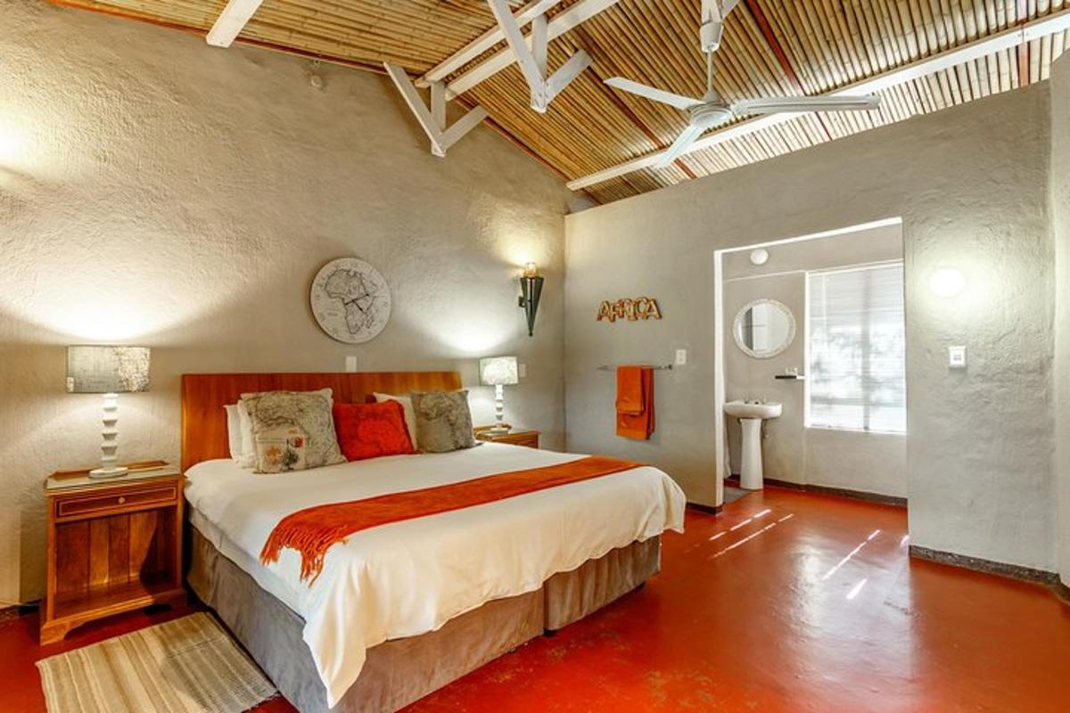 a bedroom with a bed and a clock on the wall