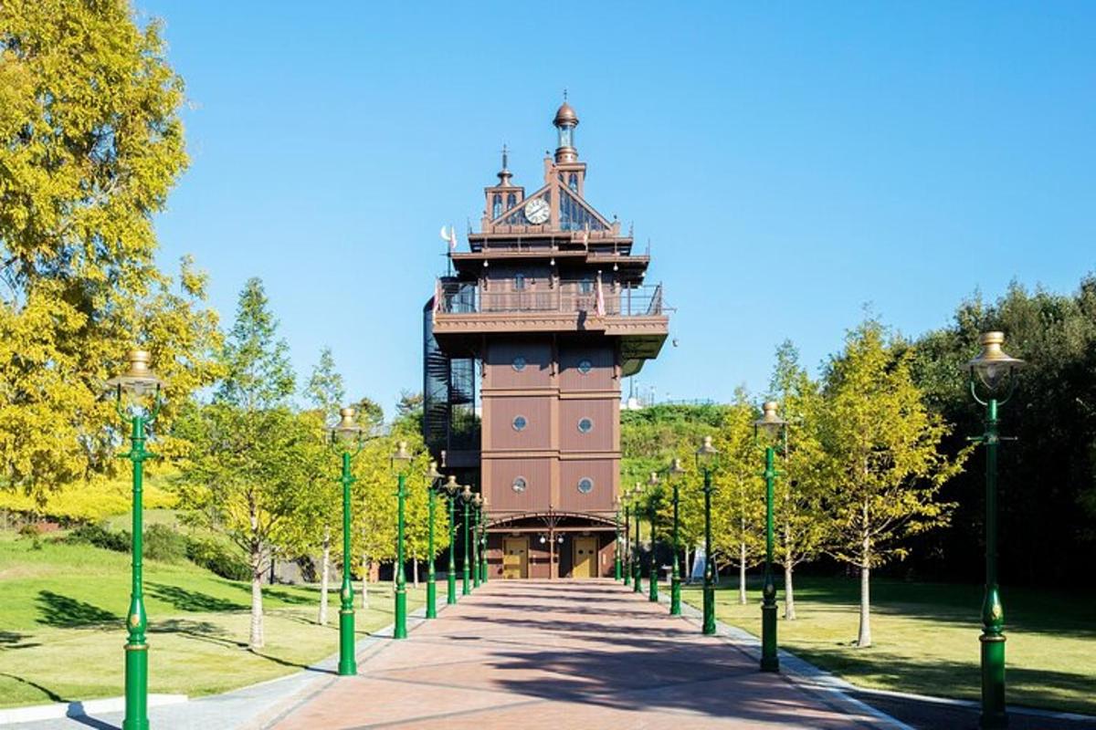 a clock tower in a park with trees and lights