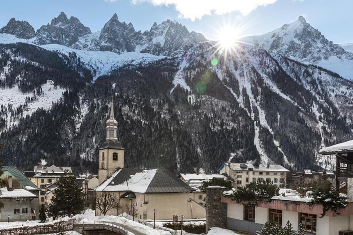 a town with a snow covered mountain in the background
