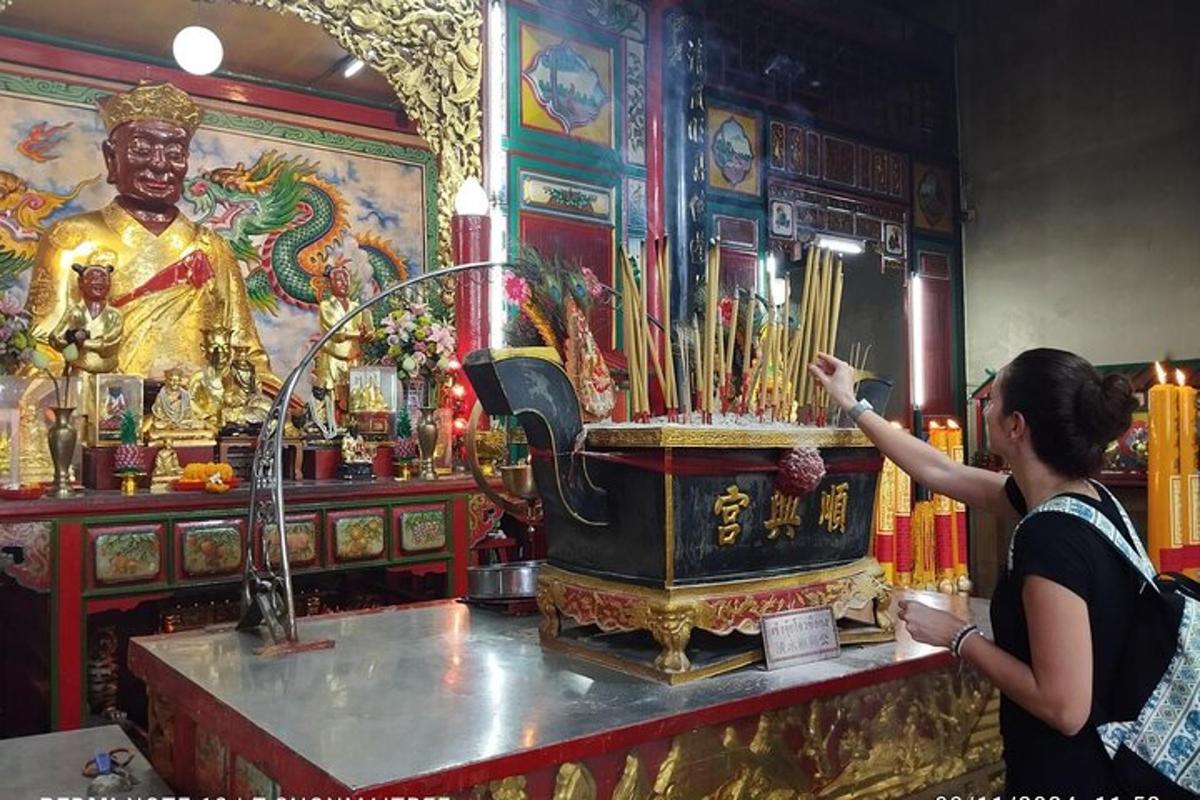 a woman standing next to a shrine in a temple