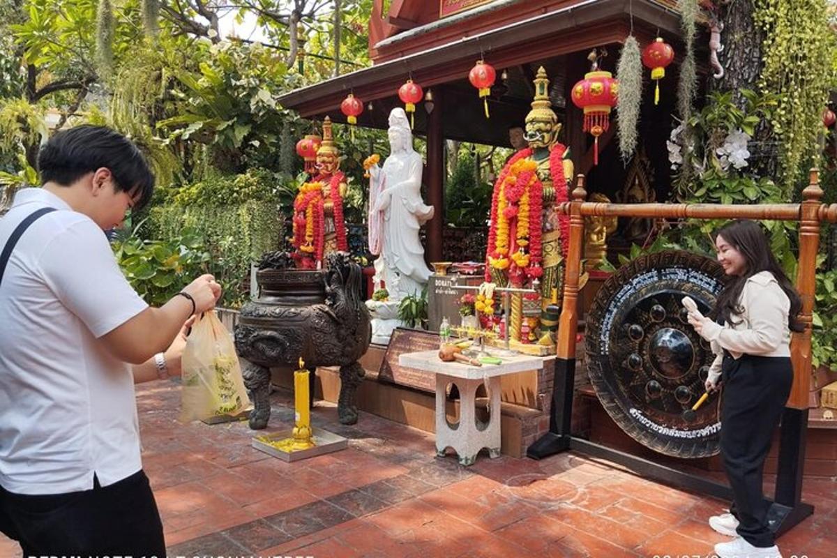 a man and a woman standing in front of a shrine