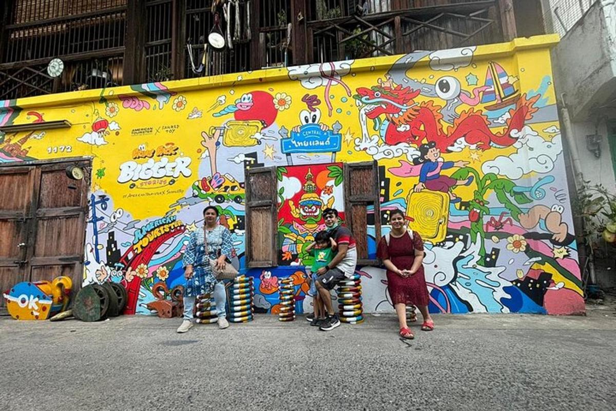 a group of people standing in front of a wall with graffiti