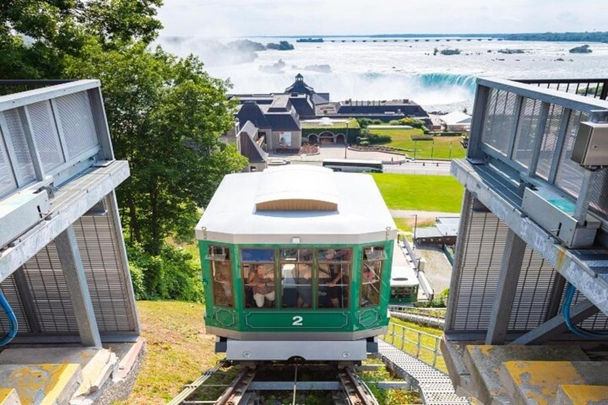 a green and white train on the tracks