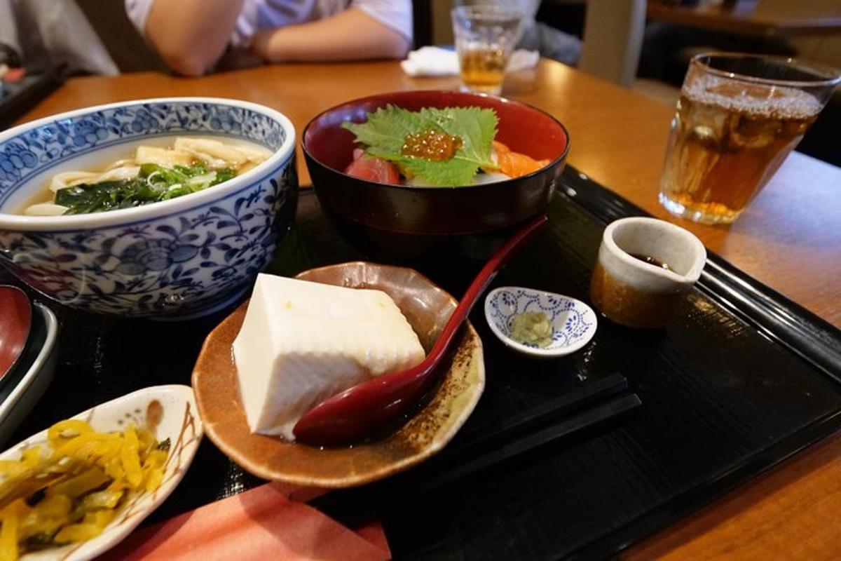 a tray with bowls of food on a table