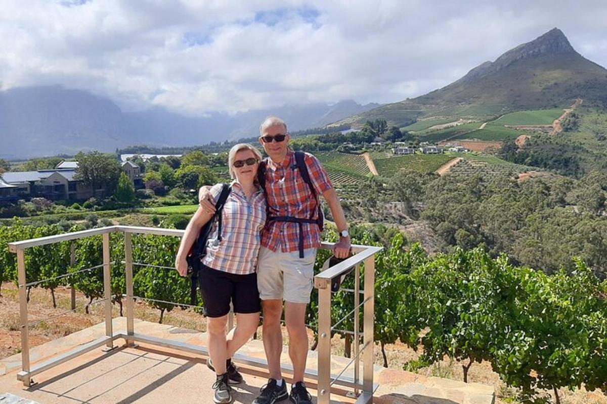 a man and woman posing for a picture on top of a mountain