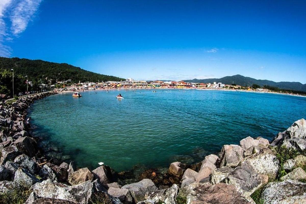 a large body of water with people swimming in it