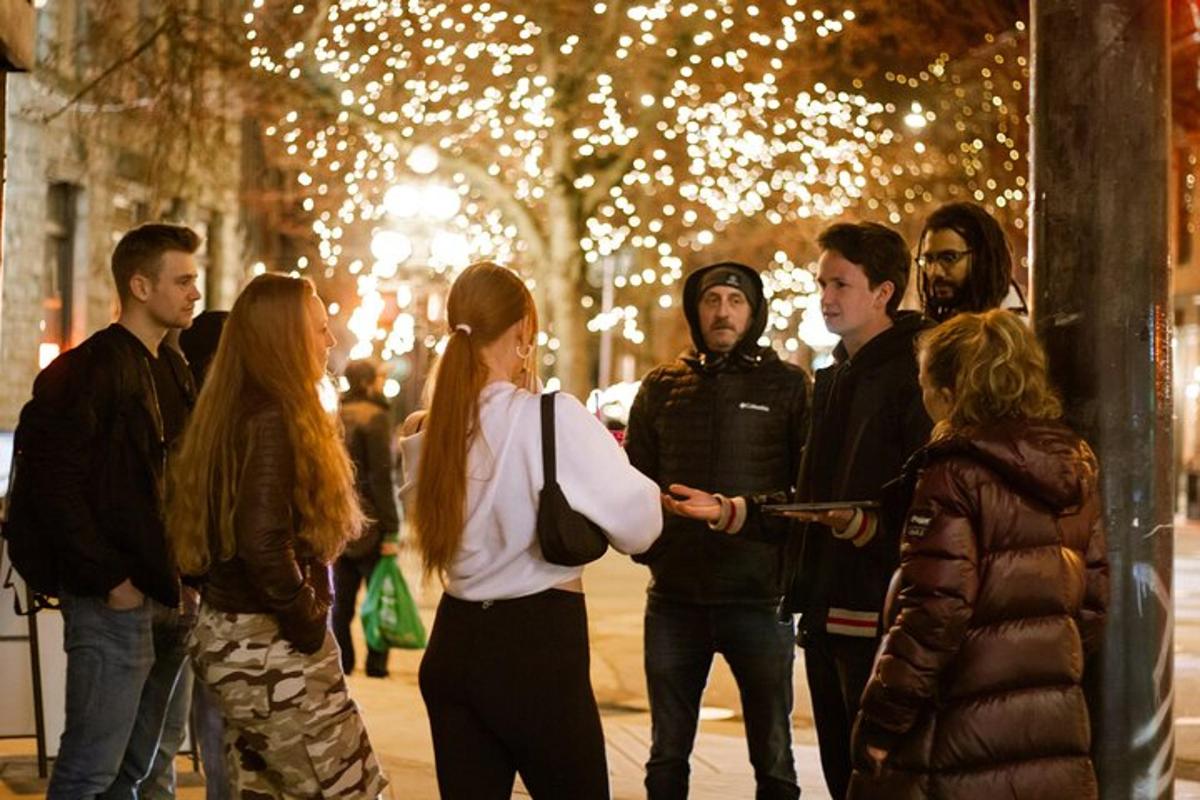 a group of people standing on a street at night