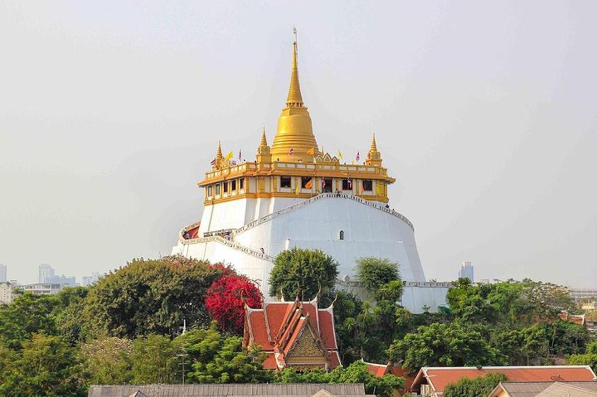 a large building with a gold top on a hill