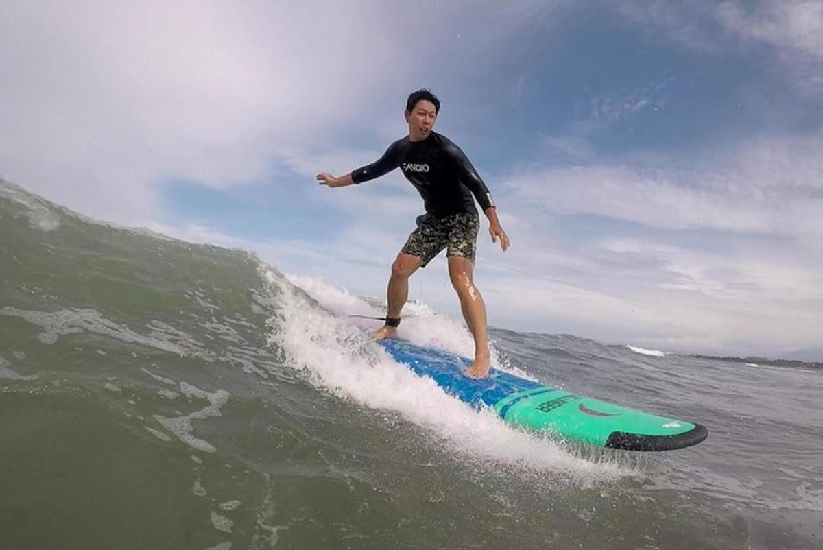 a man riding a wave on a surfboard in the ocean