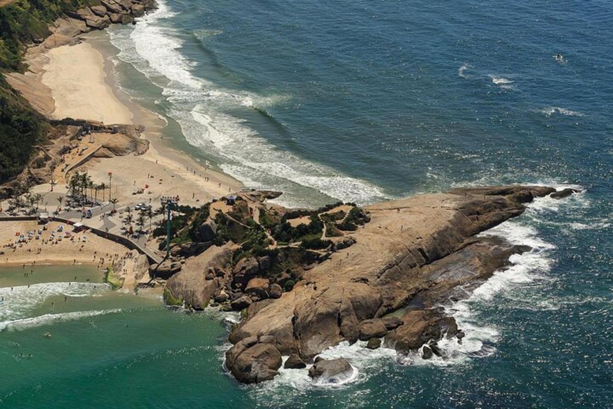 an aerial view of a beach with people on the shore