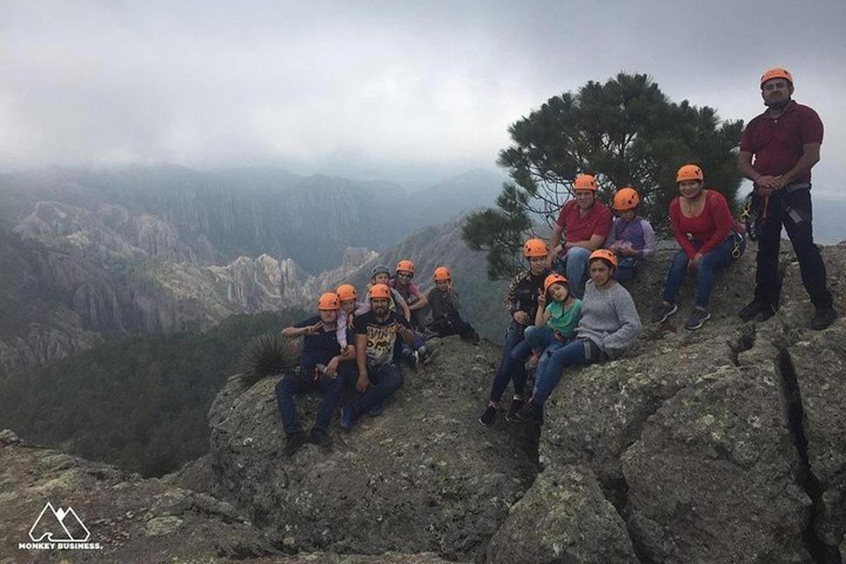 a group of people sitting on top of a mountain