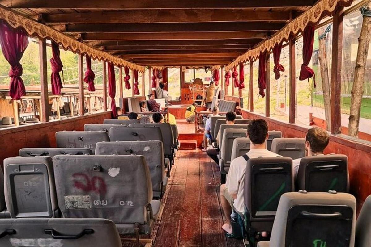 a train car with people sitting in the seats