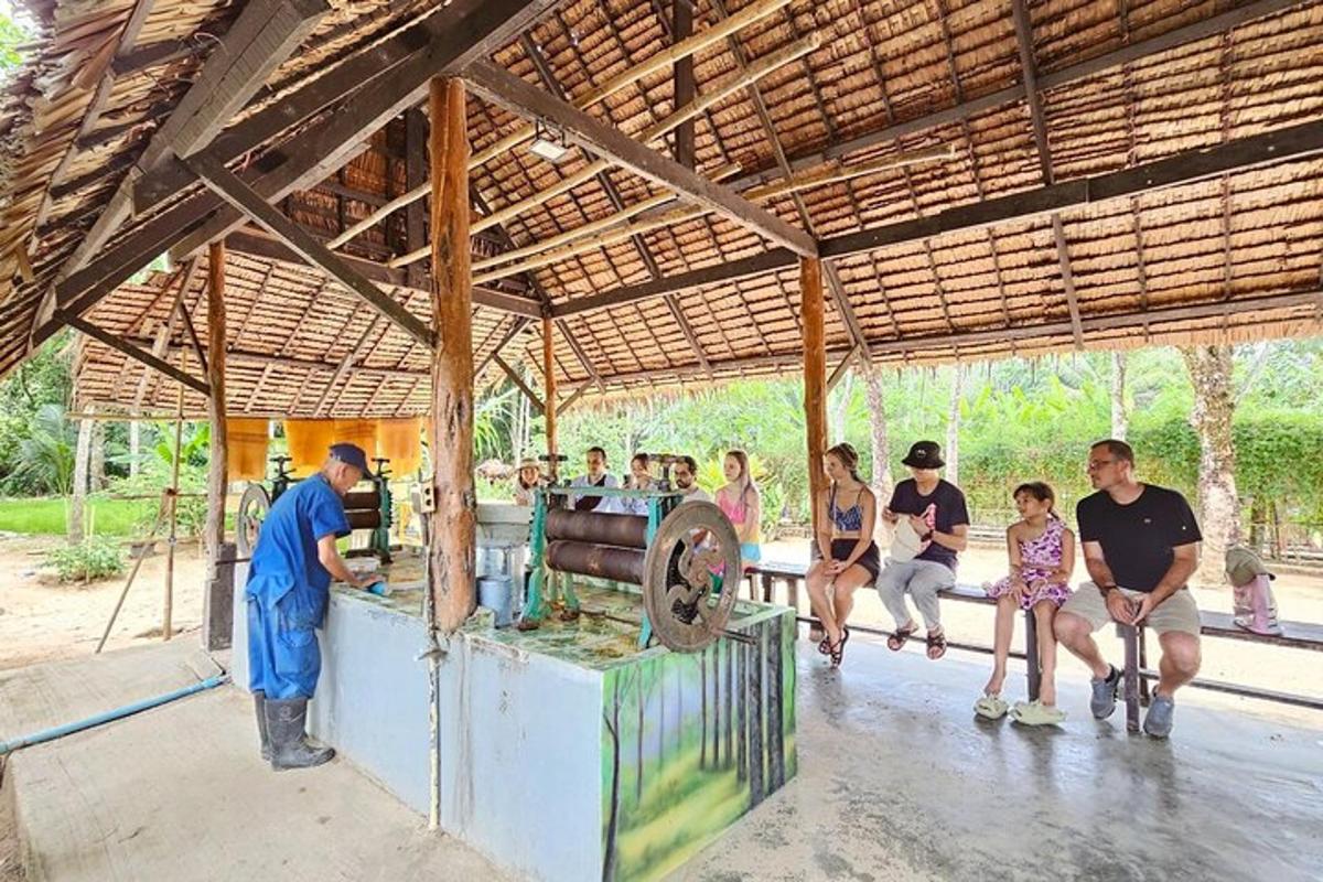 a group of people sitting on a bench in a pavilion