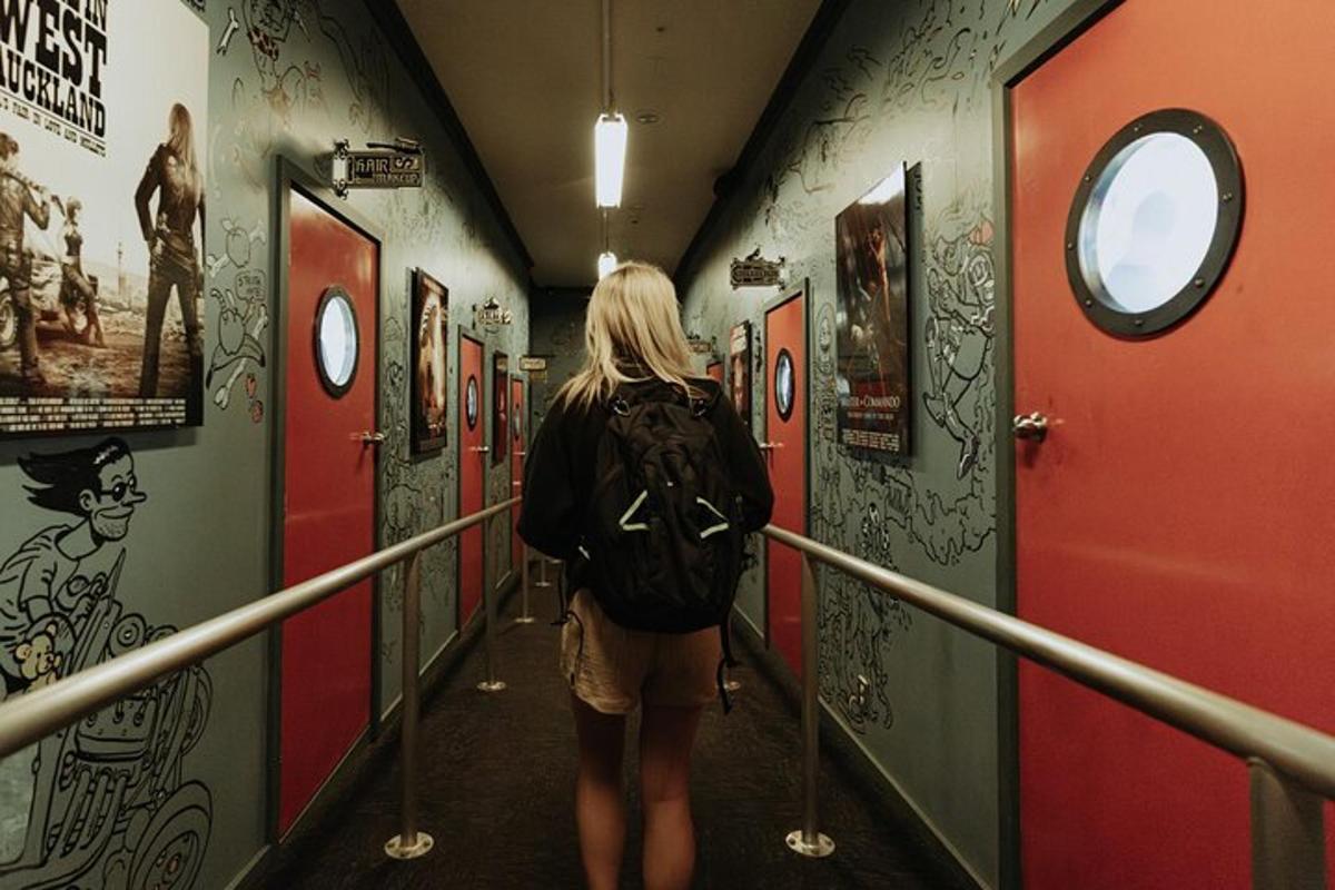 a woman walking down a hallway in a subway
