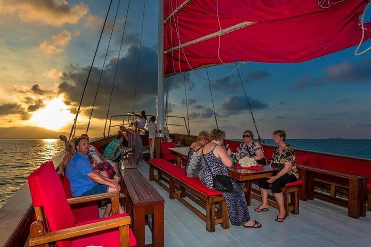a group of people sitting at tables on a boat