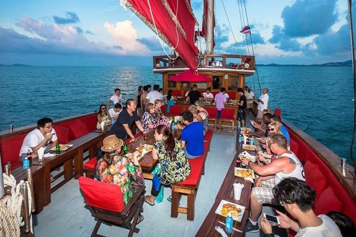 a group of people sitting at tables on a boat